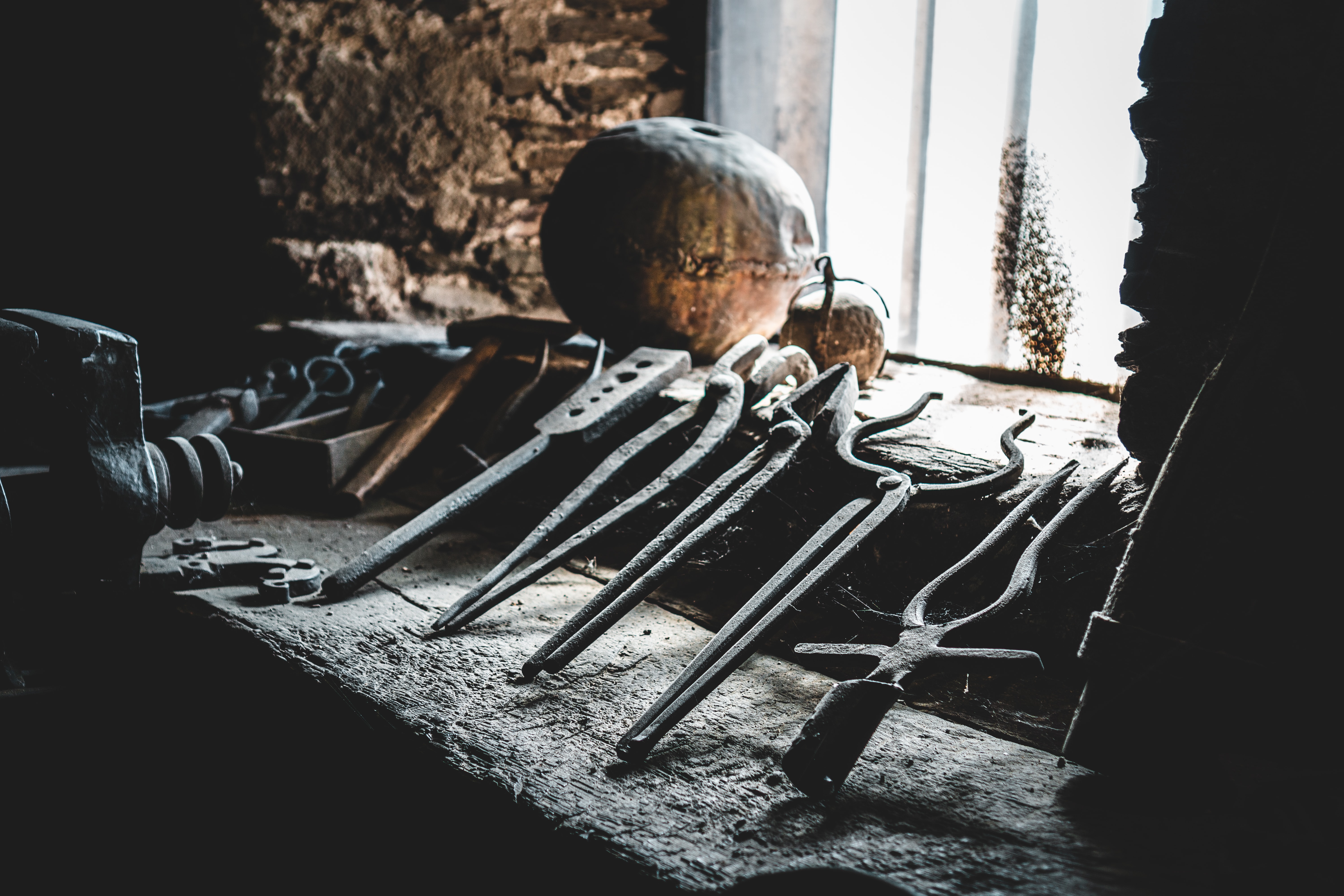 a variety of metal work sitting upright by a window