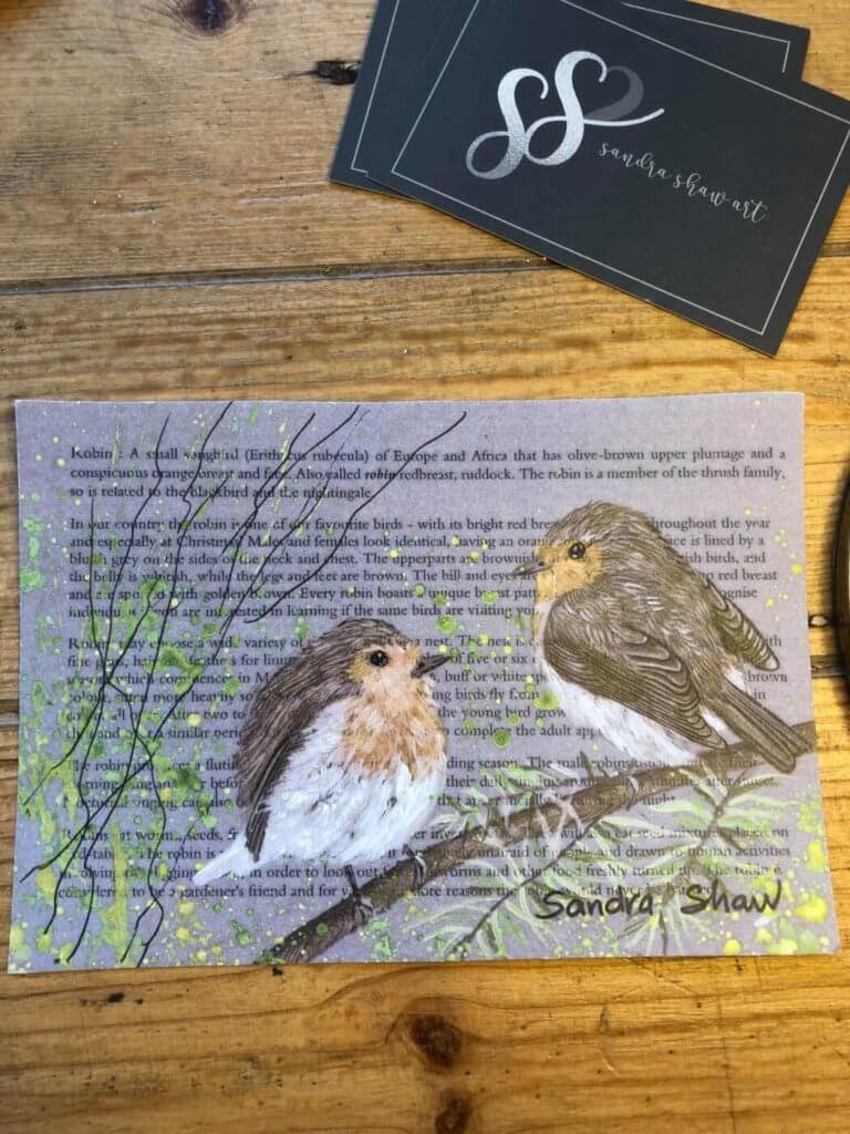 a print of two robins with a poem in the background