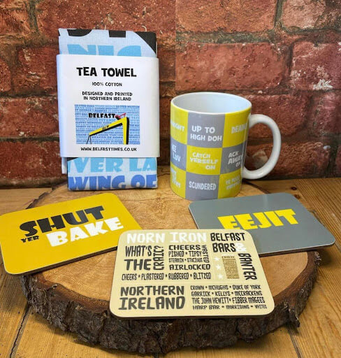 norn iron phrases on coasters, mugs, and tea towels in yellow